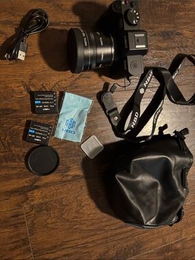 NBD Black Mirrorless Camera with Black Lens and Accessories